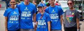 Associates wearing Sears Care to Dream T-shirts smile as they prepare for the event.